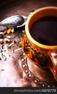 Warm herbal tea. Clay cup with herbal tea on a vintage background