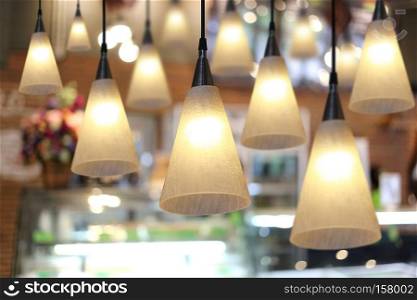 Warm lighting modern ceiling lamps in the cafe and interior decoration restaurant.