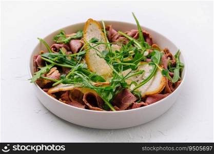 warm salad of veal and arugula with almonds
