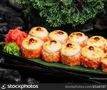 Warm Sushi Roll with Salmon and Cream Cheese served on a black board