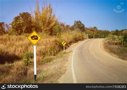 Warning road sign uphill and road curve - Steep grade hill traffic sign