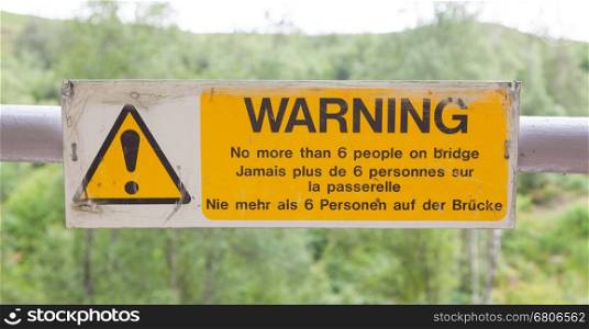 Warning sign at a bridge, no more than 6 people on bridge