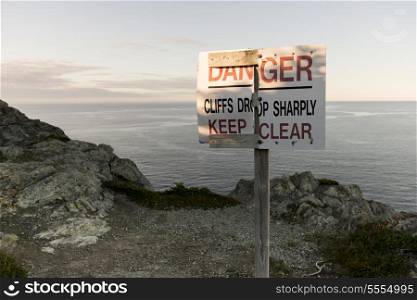 Warning signboard at coast, Long Point Hiking Trail, Crow Head, Twillingate, North Twillingate Island, Newfoundland And Labrador, Canada