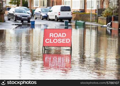 Warning Traffic Sign On Flooded Road
