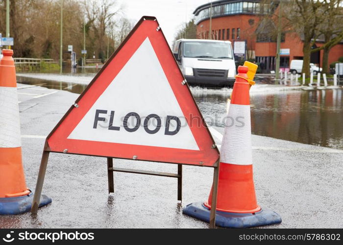 Warning Traffic Sign On Flooded Road