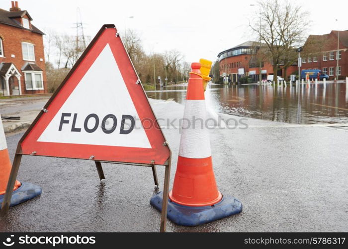 Warning Traffic Sign On Flooded Road