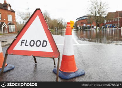 Warning Traffic Sign On Flooded Road