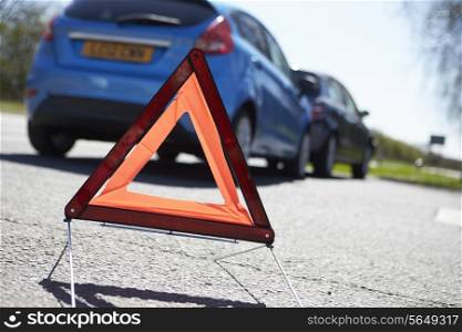 Warning Triangle By Two Cars Involved In Accident