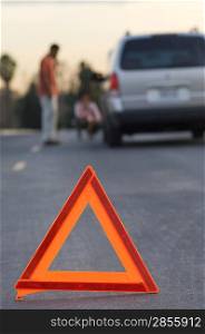 Warning triangle in front of broken down car