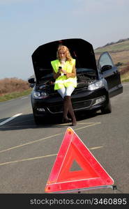 Warning triangle set on the road by broken down car