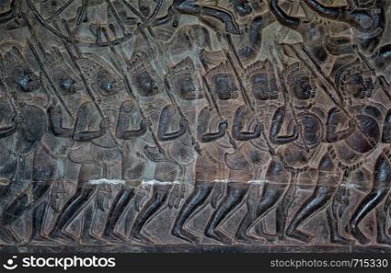 Warriors - bas relief in Angkor Wat in Cambodia. Ancient khmer art