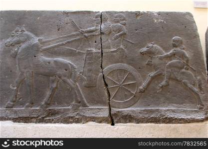 Warriors with chariot on the bas-relief on the sandstone in Archeological museum in Istanbul