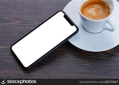 WARSAW, POLAND - DECEMBER 02, 2017: New Iphone X modern mobile phone with cup of black coffee. New Iphone X. New Iphone X