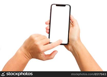 WARSAW, POLAND - DECEMBER 02: Two hands holding and touching new Iphone X with home page of mobile phone over white background. New Iphone X. New Iphone X