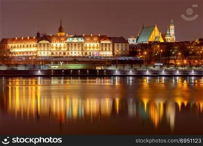 Warsaw. The city embankment.. View of the city embankment at night with a reflection in the river. Warsaw. Poland.