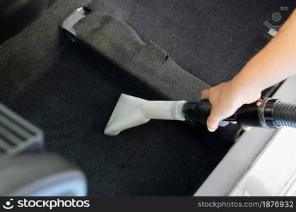 Wash the car carpet.Detailing on interior of modern car.Vacuum and clean the inside of the car.