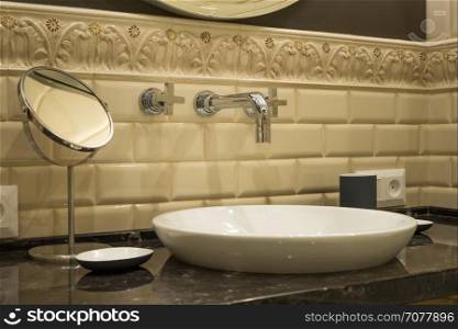 Washbasin faucet mirror in a luxurious bathroom
