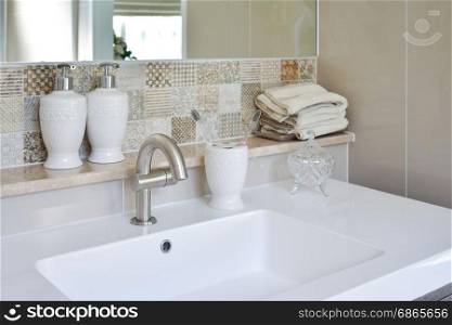 washbasin with faucet and liquid soap bottle at home