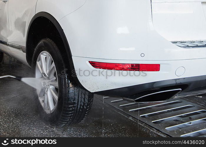 washing car closeup. car washing with high pressure water