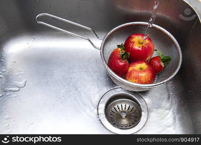 Washing fruits in the kitchen sink