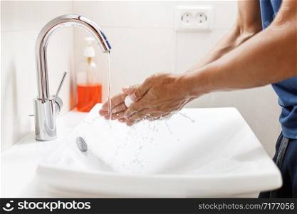 Washing hands with soap. Man cleaning hands in a bathroom.. Washing hands with soap. Man cleaning hands in a bathroom