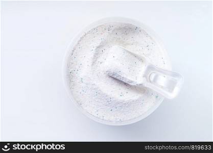washing powder with measuring cup on a washing powder box isolated on white background