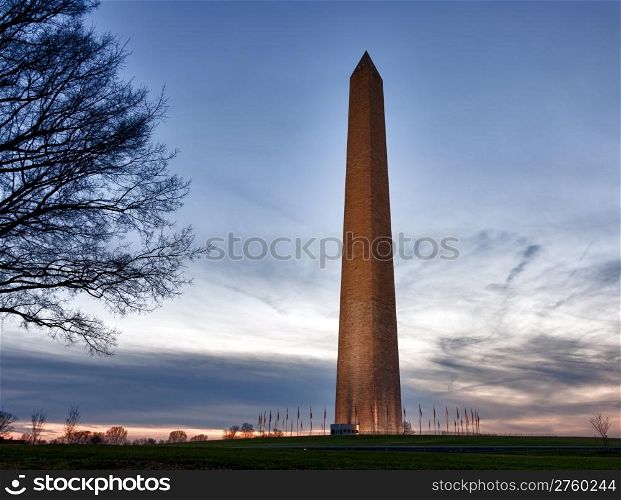 Washington Monument in DC at dusk as the sun is setting and tower is illuminated