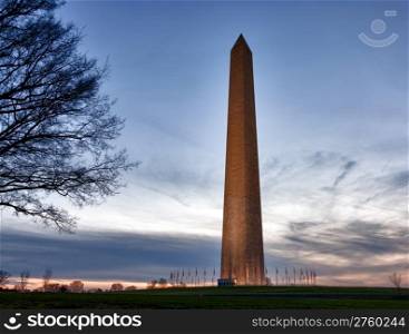 Washington Monument in DC at dusk as the sun is setting and tower is illuminated