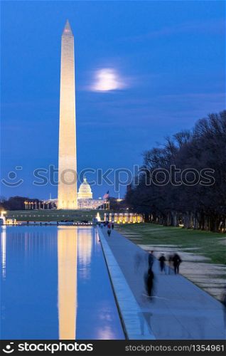 Washington Monument in new reflecting pool from Lincoln Memorial at sunset night.This monument is obelisk on the National Mall one of landmark of Washington DC USA.