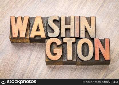 Washington word abstract in vintage letterpress wood type printing blocks against grained wooden background