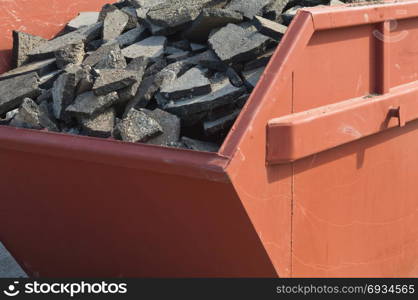 Waste asphalt pavement and concrete materials in waste container