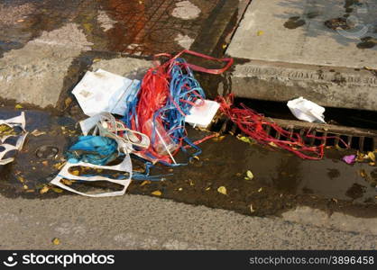 Waste at manhole on street of city, the environment problem at developing countries, from poor awareness, rubbish make polluted city