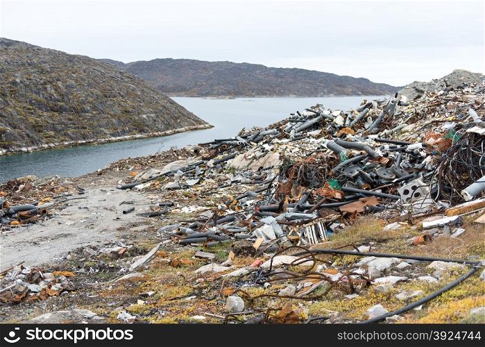Waste disposal site in Aasiaat, Greenland with old pipes