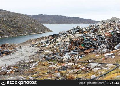Waste disposal site in Aasiaat, Greenland with old pipes