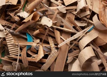 Waste paper as background texture. Recycling concept and brown cardboard heap