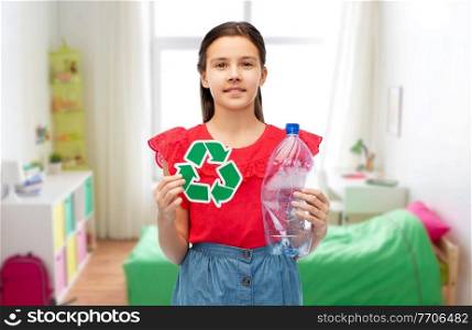 waste sorting and sustainability concept - smiling girl holding green recycling sign and plastic bottle over white background. girl with green recycling sign and plastic bottle