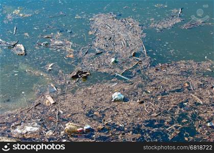 Waste, trash and garbage floated on a polluted river