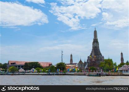 Wat Arun, Bangkok&rsquo;s main attractions. The tower and adjacent river.