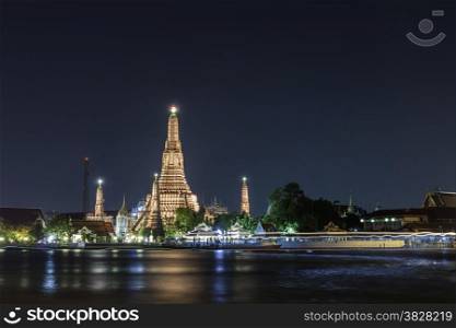 Wat Arun ( Temple of Dawn ) at night along with Chaopraya river, Bangkok, Thailand.