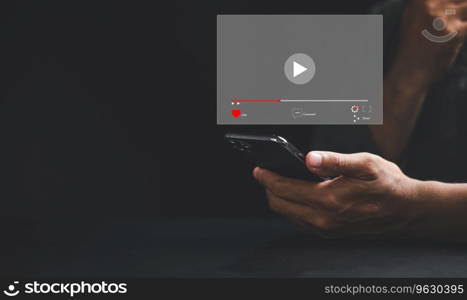 Watch captivating videos on a smartphone screen as a man taps to start live streaming. Immerse yourself in the digital world of technology, social media, and entertainment from the comfort of home.