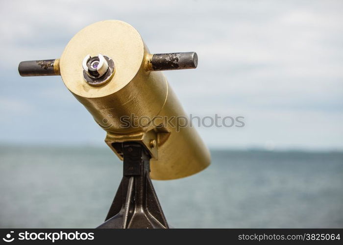 watching sea ocean trought binoculars telescope on a turistic tower. travel and tourism