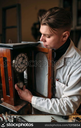 Watchmaker repair clock pendulum mechanism. Antique mechanical watch repairing