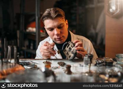 Watchmaker repair old mechanical clocks. Clock maker at work