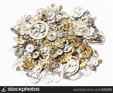watchmaker workshop - heap of used watch spare parts on white background