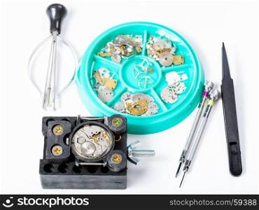 watchmaker workshop - tools and spare parts for repairing watch on white background