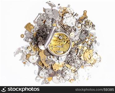 watchmaker workshop - top view of open silver pocket watch on pile of old clock spare parts on white background