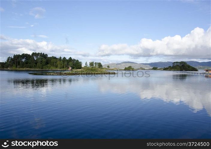 Water and lake with islands and clouds, ocean around Bergen in Norway