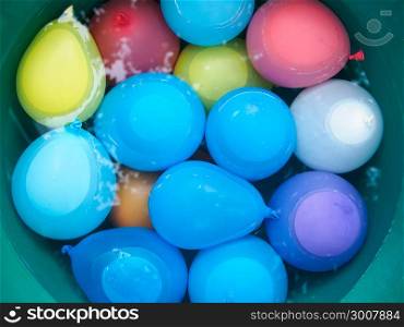 water balloons in a bucket with water