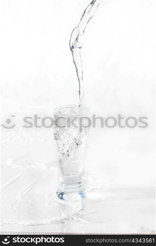 Water being poured in a transparent glass