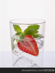 Water detox with fresh strawberries and mint leaves. Strawberry lemonade with lemon and mint. Water detox